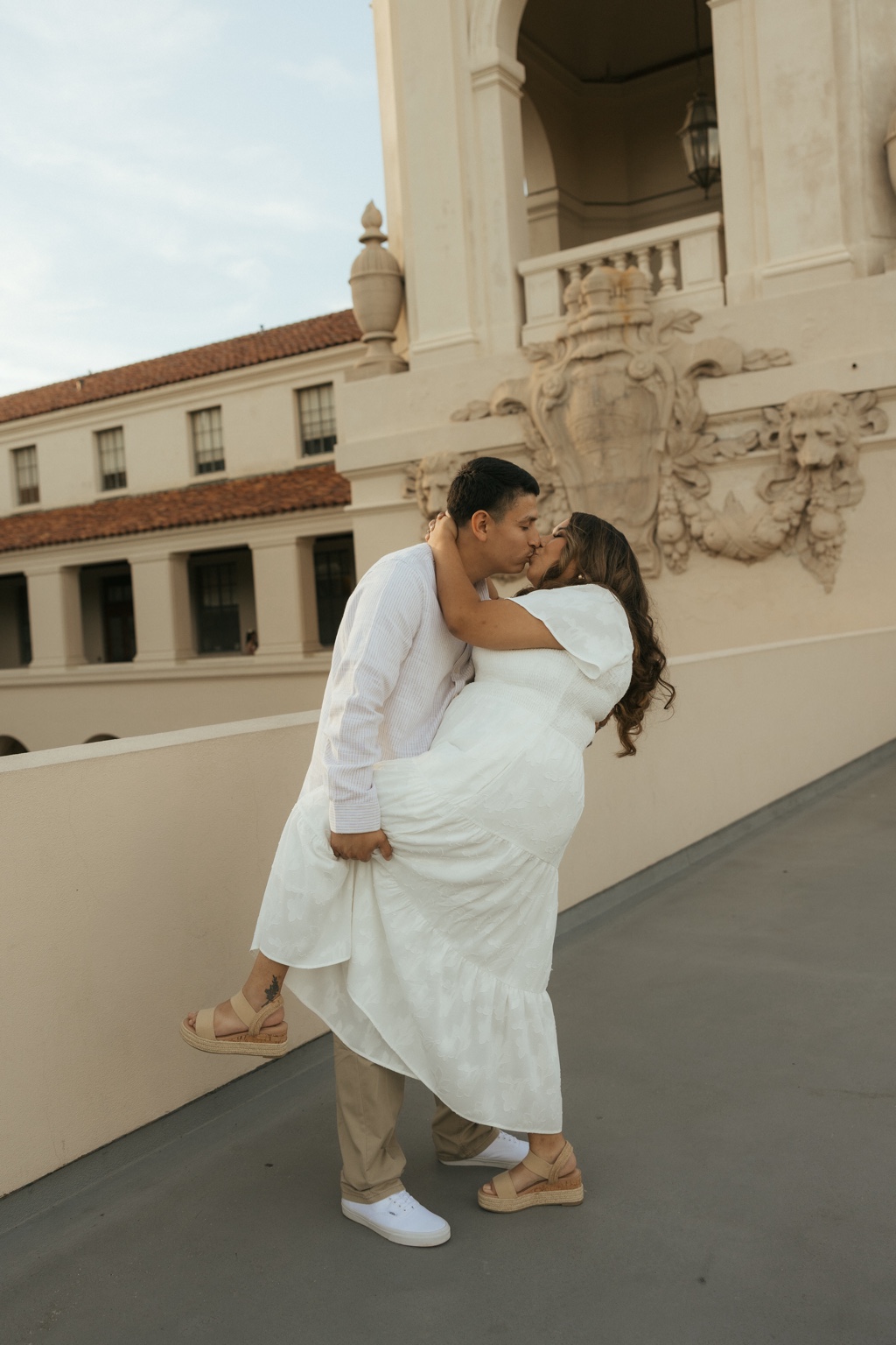 Julian lifting Natalie as they share a kiss
